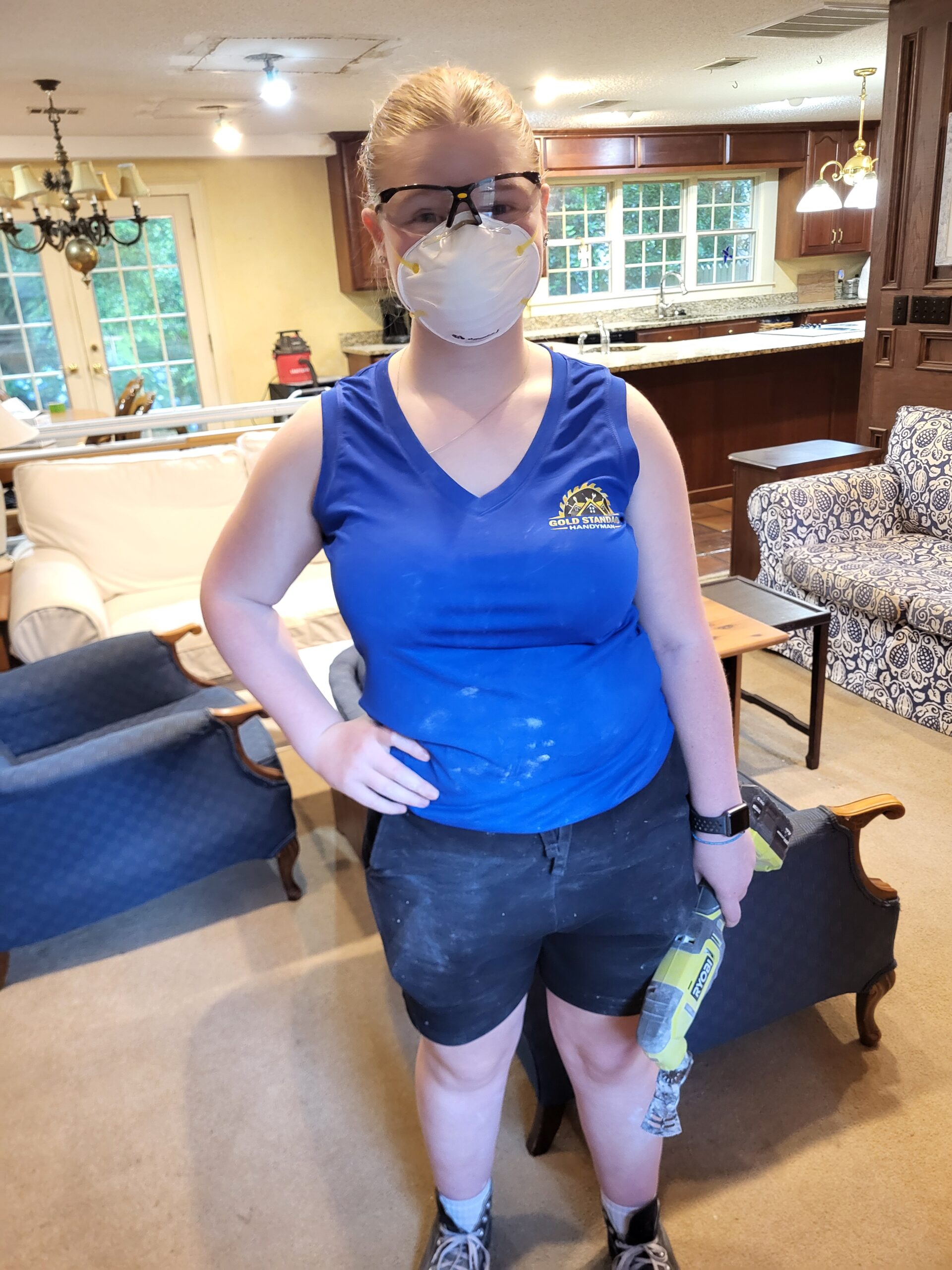 Katie helping on a customer project in a Gold Standard Handyman work shirt