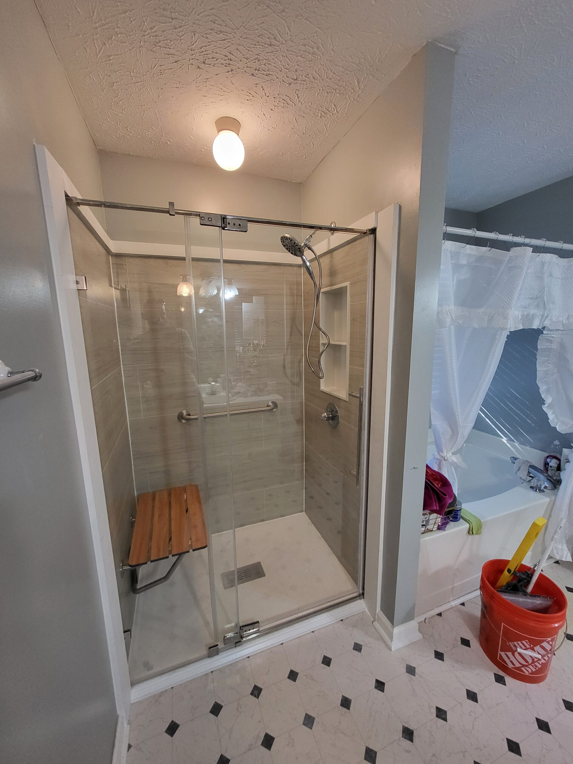 Completed VA HISA accessible shower remodel with grab bar and bench seat